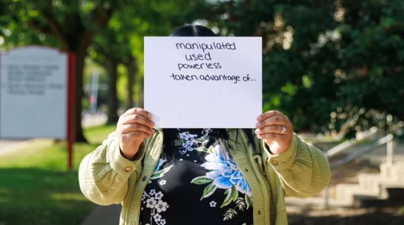 Daisy is a former crisis counselor at the 988 call center in Bloomington, Ill. He holds a piece of paper in front of his face that lists the emotions he felt when he made harassing phone calls while working there. She covers her face to keep her name anonymous because she doesn't want her or professional networks to know about the abuse. Daisy was the name she used for callers to her work shifts.