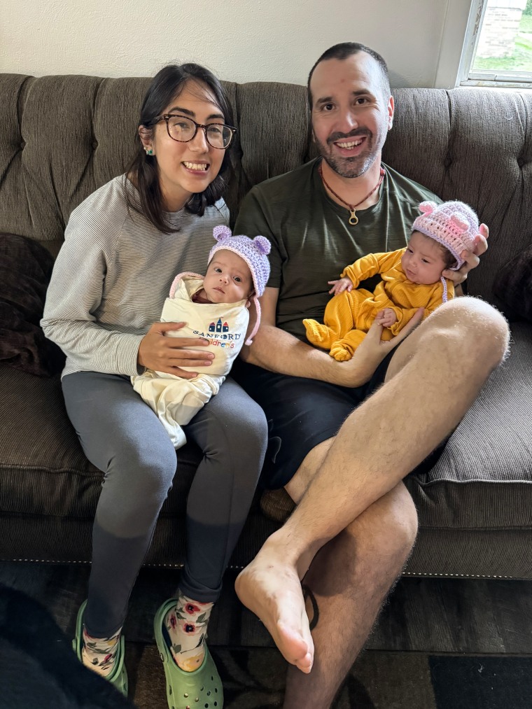 Wesley Bruce and Ashley Perez are holding their twins.