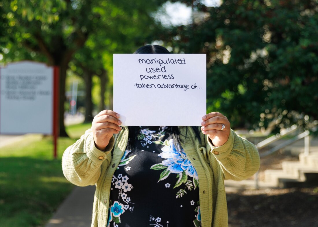 Daisy is a former crisis counselor at the 988 call center in Bloomington, Ill. He holds a piece of paper in front of his face that lists the emotions he felt when he made harassing phone calls while working there. She covers her face to keep her name anonymous because she doesn't want her or professional networks to know about the abuse. Daisy was the name she used for callers to her work shifts.